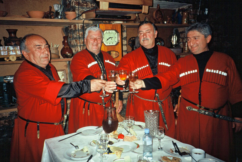 Toasting at a traditional Georgian Table. Photo credit: Michel Behar