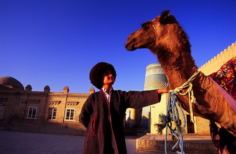 A local offers a camel ride in Old Town Khiva, Uzbekistan. Photo credit: Peter Guttman