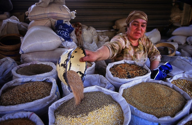 A vendor measures out grains for sale at the market. Photo credit: Peter Guttman