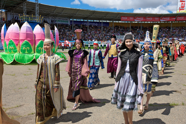 Young women parade in Mongolian costumes at Naadam Festival opening ceremonies in Ulaanbaatar. Photo credit: Helge Pedersen