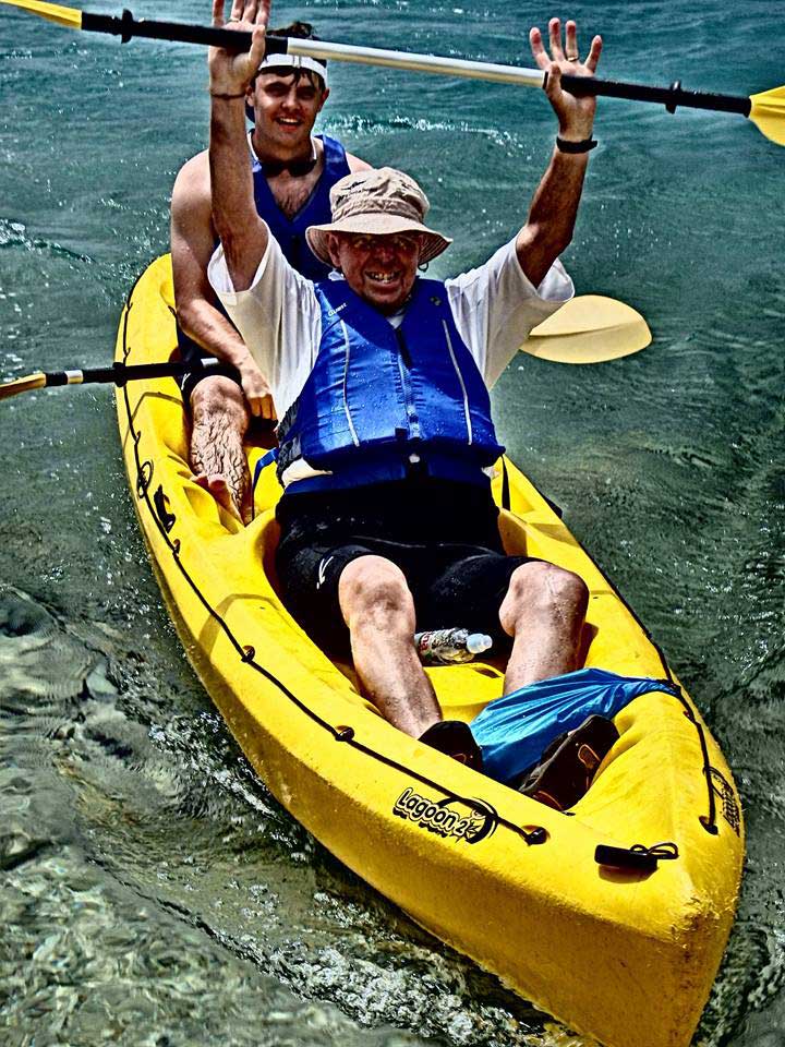 Grandfather jubilantly sea-kayaks with his grandson in Croatia on a custom journey. Photo credit: Iris Adventures