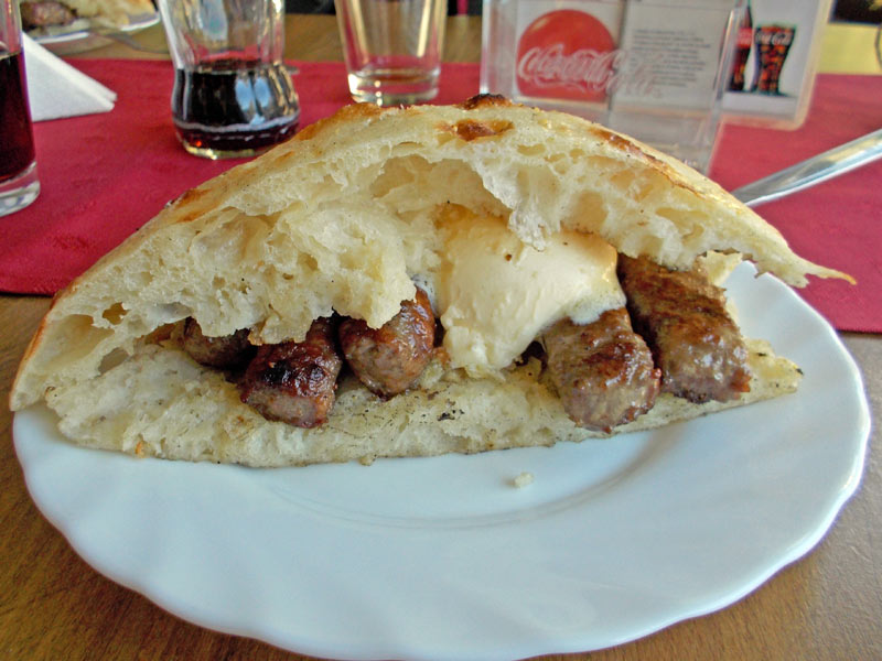 Cevapi are typically smothered in kaymak, a popular condiment similar to clotted cream. Photo credit: Lisa Peterson