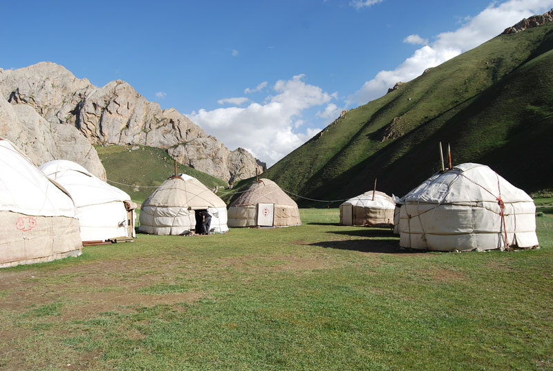 Camp out in the Kyrgyz highlands in traditional yurts, like the ones shown here in Tash Rabat. Photo credit: Douglas Grimes