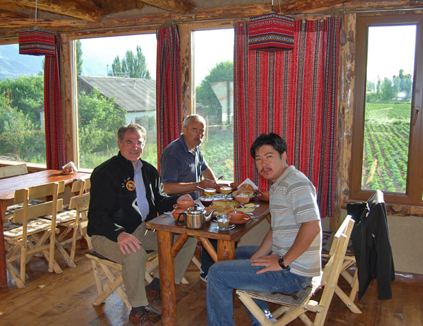 MIR President Douglas Grimes in this sun-filled Chon-Kemin guesthouse; crops in the background. Photo credit: Douglas Grimes