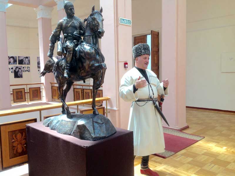 Traditionally-dressed Circassian man talks about the customs of his culture at the museum. Photo credit: Michel Behar