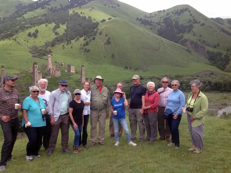 Travelers pose in front of stone watchtowers in Ingushetia. Photo credit: Michel Behar