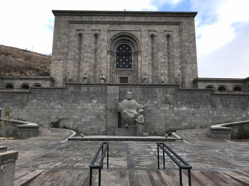 A statue of the Matenadaran’s namesake — St. Mesrop Mashtots, the inventor of the Armenian alphabet — stands just in front of the building complex. Photo credit: Jessica Clark