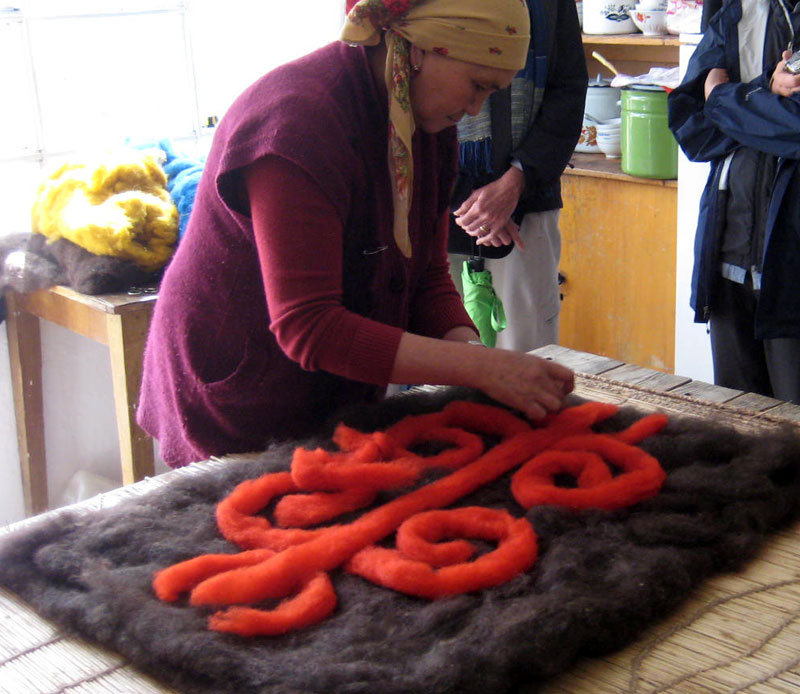 Laying out the felt pattern (Kyrgyzstan). Photo credit: Paul Schwartz