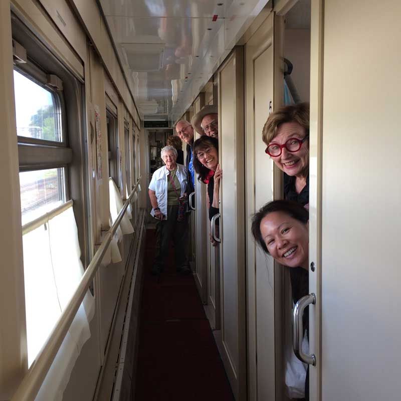 Travelers peeking from their cabins into the corridor. Photo credit: Anna Ivanova
