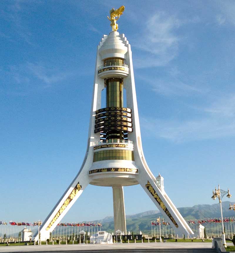 At the top of the Monument of Neutrality, another golden statue of Turkmenbashi opens his arms in front of the Turkmen flag (Ashgabat, Turkmenistan). Photo credit: Michel Behar