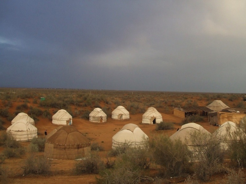 A traditional yurt camp out in the red sands of the Kyzyl Kum Desert. Photo credit: Andrei Baev
