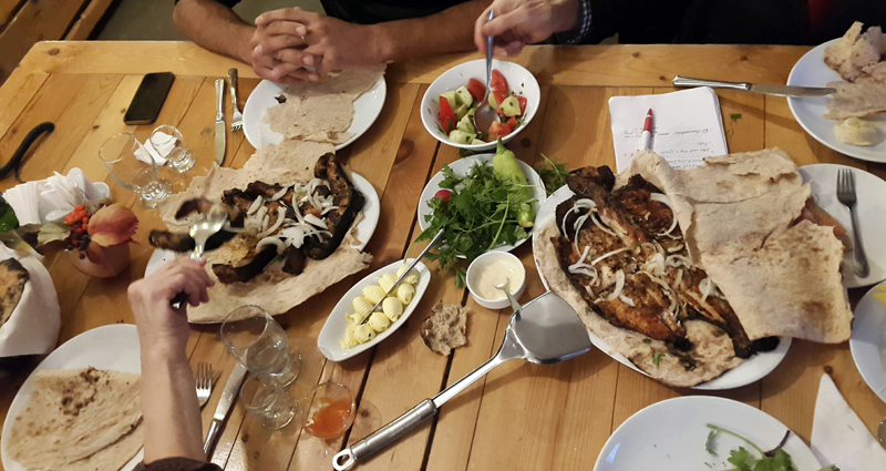 Sitting down to a meal of grilled fish at Gyumri’s Cherkezi Dzor Restaurant. Photo credit: Anya von Bremzen