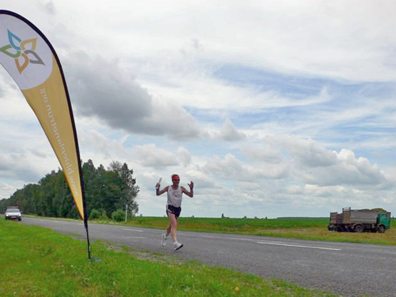 A Blue Planet runner strides along a rural road in Belarus. Photo credit: Douglas Grimes