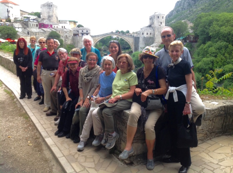 Patricia and her fellow travelers pose in front of Mostar Bridge in Bosnia & Herzegovina. Photo credit: Michel Behar