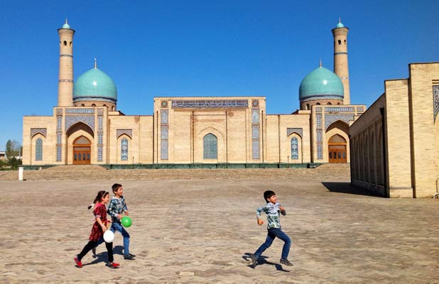 A mix of old and new, as young kids play outside Tillya Sheikh Mosque in Tashkent. Photo credit: Michel Behar