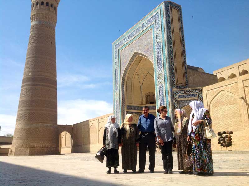 Patricia Schultz, author of 1,000 Places to See Before You Die, traveled with MIR in 2014; here she's pictured with a group of locals in Uzbekistan. Photo credit: Michel Behar