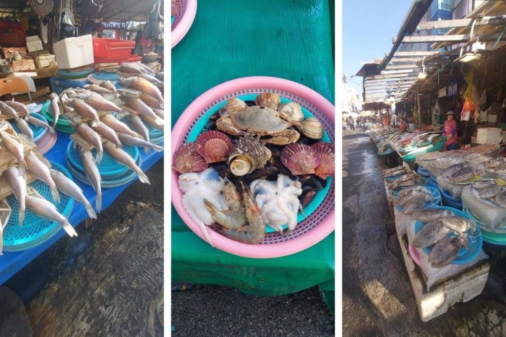 Fresh seafood at Jagalchi Market in Busan. Fish, shrimp, crabs, and shellfish fill colorful baskets. Vendors sell their catch along busy stalls.